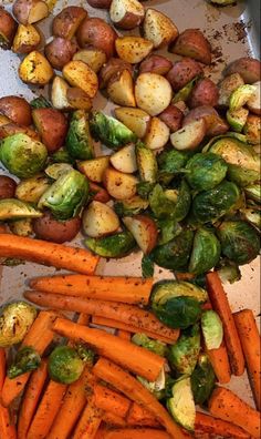 there are many different types of vegetables on the tray together, including carrots and brussel sprouts