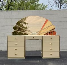 an old dresser with a large mirror on it's top and two drawers below