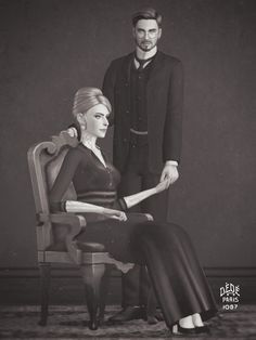 a man standing next to a woman sitting on a chair in front of a black and white photo