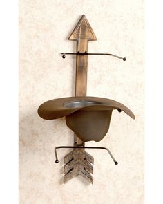 a metal hat rack with an arrow on it