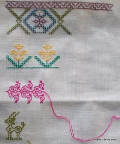 three different types of stitching on fabric, one with flowers and the other with an arrow