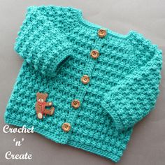 a crocheted sweater with buttons and a teddy bear on it