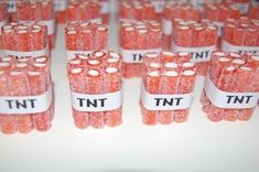 there are many pink candies wrapped in white paper and labeled with the words tnt