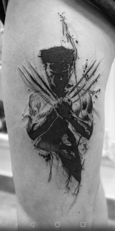 a black and white photo of a person with a wolverine tattoo on his thigh,