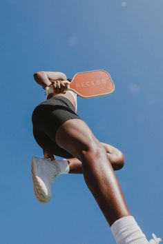 a person jumping in the air with a skateboard on their feet and one leg up