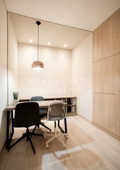 an office with a desk and chair in the corner, next to a book shelf