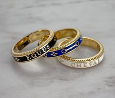 A new addition to our stackable Equus Rings! Featuring an eternity design of classic English snaffle bits & stars with beaded edges. Exquisitely crafted in 18k yellow gold and enamel. Absolutely gorgeous paired with our Lace Rein & Diamond Stack Rings. A fabulous addition to your style from the show ring to out on the town. Available in Hampton Blue, Midnight Black & Classic White enamel. 18 karat Yellow Gold Enamel 4.5mm wide Handmade in the US Create Your Own Heirloom. Contact us for custom op June Aesthetic, Snaffle Bit, Stack Rings, Diamond Stacks, Enamel Ring, Midnight Black, Gold Enamel, White Enamel, Stacking Rings