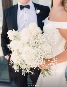 a bride and groom pose for a wedding photo