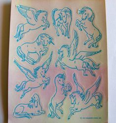 a sheet of blue stickers with horses and angels on the back of each one