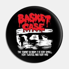 a black and red button with the words basket case on it's front side