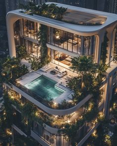 an aerial view of a modern building with pool and greenery on the top floor