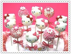 hello kitty lollipops are arranged on top of each other in pink and white