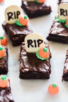 halloween brownies decorated with candy pumpkins and marshmallows are arranged on a white surface