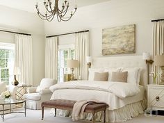 a bedroom with white furniture and chandelier in it's centerpieces