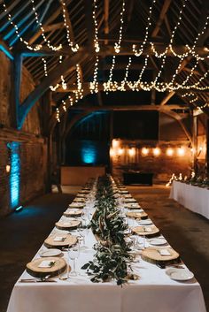 the long table is set with plates and place settings for guests to sit down at