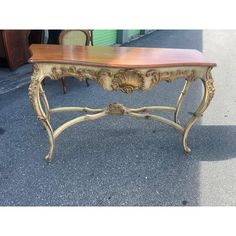 a wooden table sitting on top of a sidewalk