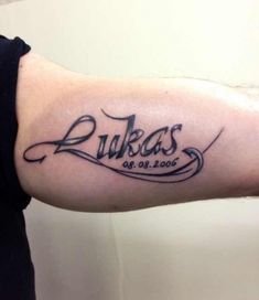 a man with a tattoo on his arm that reads luksas, and has the word