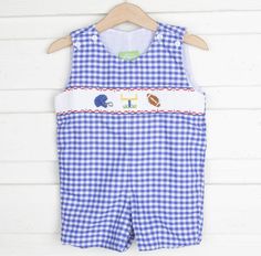 Get ready to cheer your team on this coming football season! This Jon Jon features a smocked football helmet, goalpost, and football on blue gingham. Shoulder buttons and snaps in stride. Jon jon, kids clothes, kids smocked clothing, kids closet, kids clothes ideas, kids inspo, kids football outfit ideas, gameday outfit, gingham, football kids clothes Kids Clothes Ideas, Kids Inspo, Smocked Clothes, Jon Jon, Kid Closet, Football Helmet