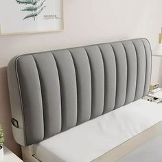 an upholstered headboard on a bed in a bedroom