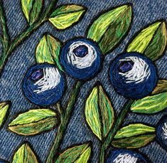 blueberries and green leaves painted on denim fabric