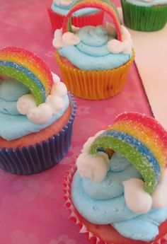 cupcakes with rainbow frosting and clouds on them