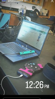 an open laptop computer sitting on top of a table