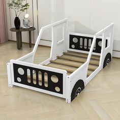 a child's bed with black and white wheels