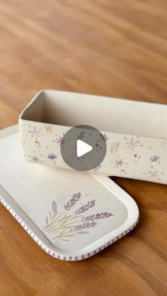 an empty tray with a flowered design on it and a video player in the middle