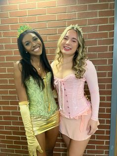 two women dressed in costumes posing for the camera