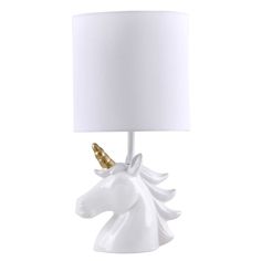 a white table lamp with a gold horn on it