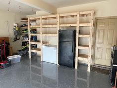 a garage with shelves, refrigerator and other items