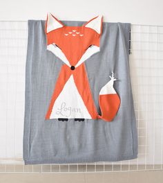 an orange and white fox towel hanging on a wall