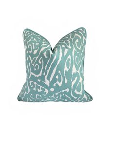 a blue and white pillow with an animal print pattern on the front, sitting on a white background