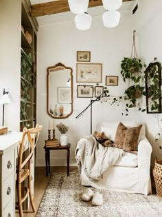 a living room filled with furniture and lots of greenery next to a wall mounted mirror