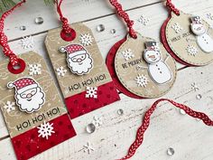 three tags with snowmen on them hanging from a christmas tree ornament decoration