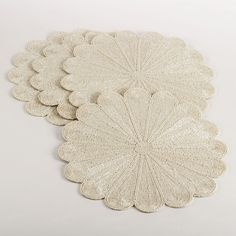 four white coasters on a white background