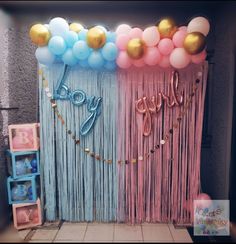 balloons and streamers decorate the backdrop for a baby shower