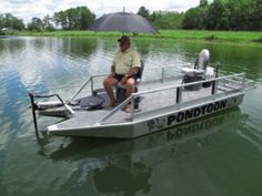 a man sitting on top of a boat in the water with an umbrella over his head