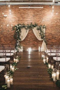 an indoor ceremony with candles and greenery