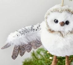 an owl ornament hanging from a christmas tree