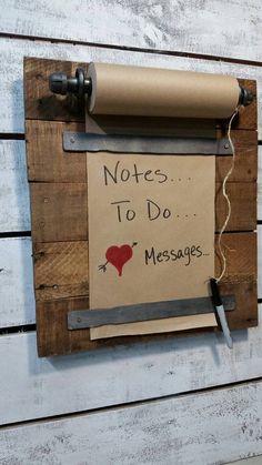 a sign that says notes to do messages attached to a wooden wall with a paper roll hanging on it