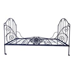 a wrought iron bed frame with an intricate design on the top and bottom, shown against a white background