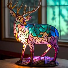 a stained glass stag lamp sitting on top of a table