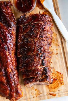 two ribs on a cutting board with ketchup