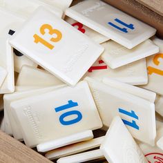 a box filled with lots of white and blue plastic numbers on top of each other