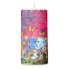 an elephant candle is decorated with flowers and butterflies