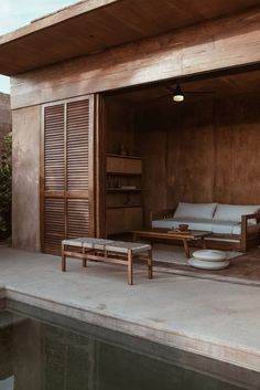 an outdoor living area with couches and tables