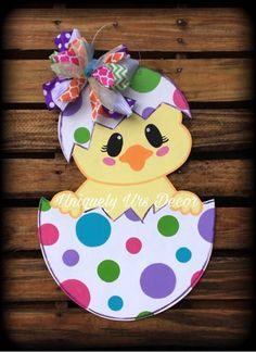 a paper cut out of an easter chick with polka dots on it's head