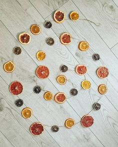 oranges and other fruits are arranged in the shape of a circle on a wooden floor