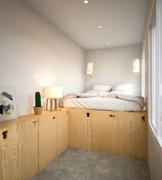 a bed sitting on top of a wooden shelf next to a window in a bedroom